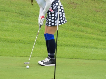 ミニスカートでプレーする女子ゴルファー